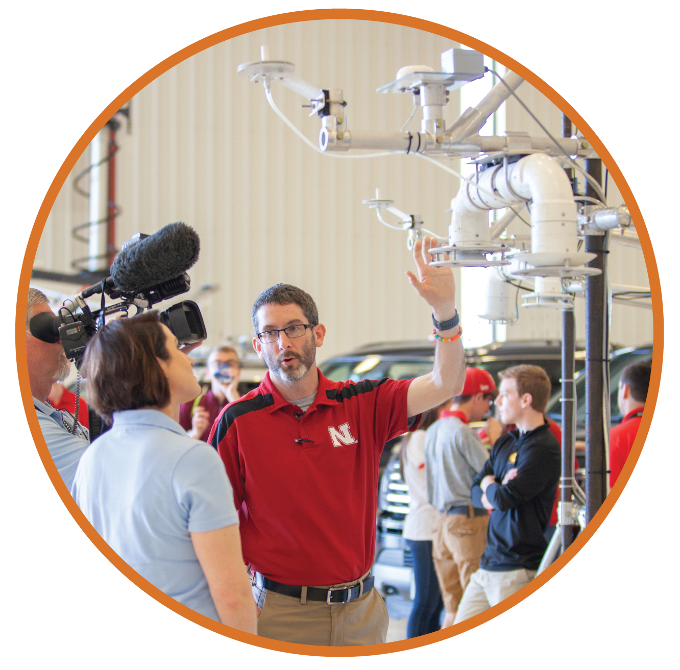 Associate Professor Adam Houston (University of Nebraska) explaining meteorological instrument to students.