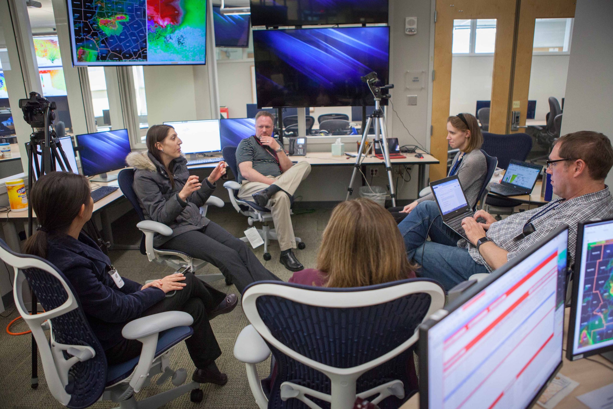 A team of weather forecasters deep in discussion. Teams across NOAA are composed of government and contract workers. Contract workers are an integral part of achieving NOAA’s mission.